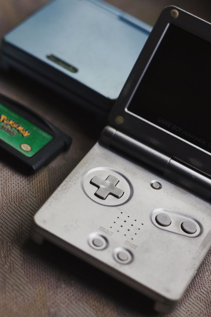 Close-up of a vintage handheld gaming console and game cartridge for nostalgic gaming enthusiasts.